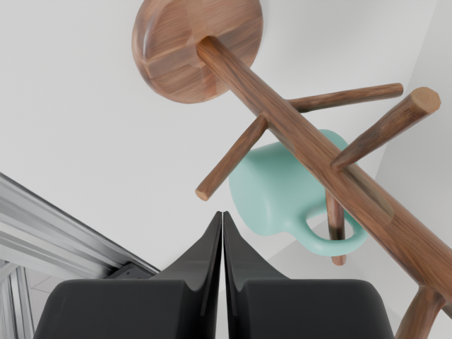 Left wrist verification: the mint mug hangs by its handle on the wooden peg, clear of the gripper.